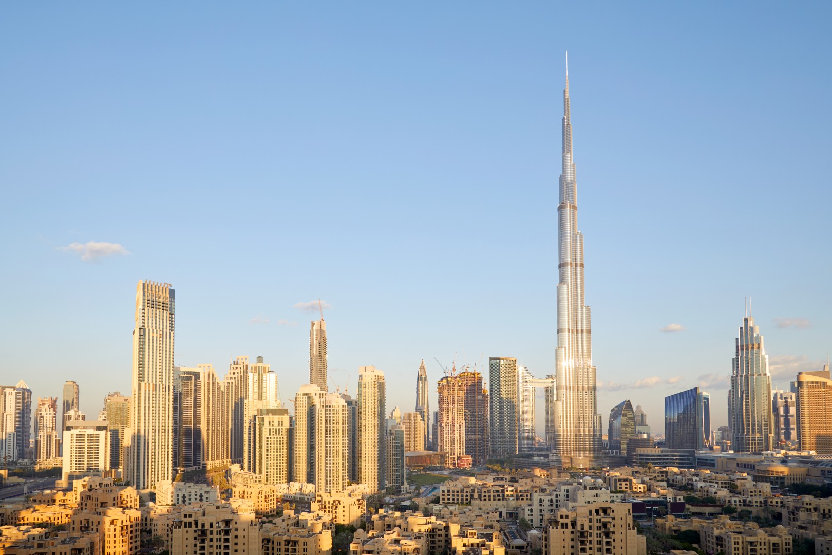 Dubai city skyline with Burj Khalifa skyscraper in a sunny day, blue sky